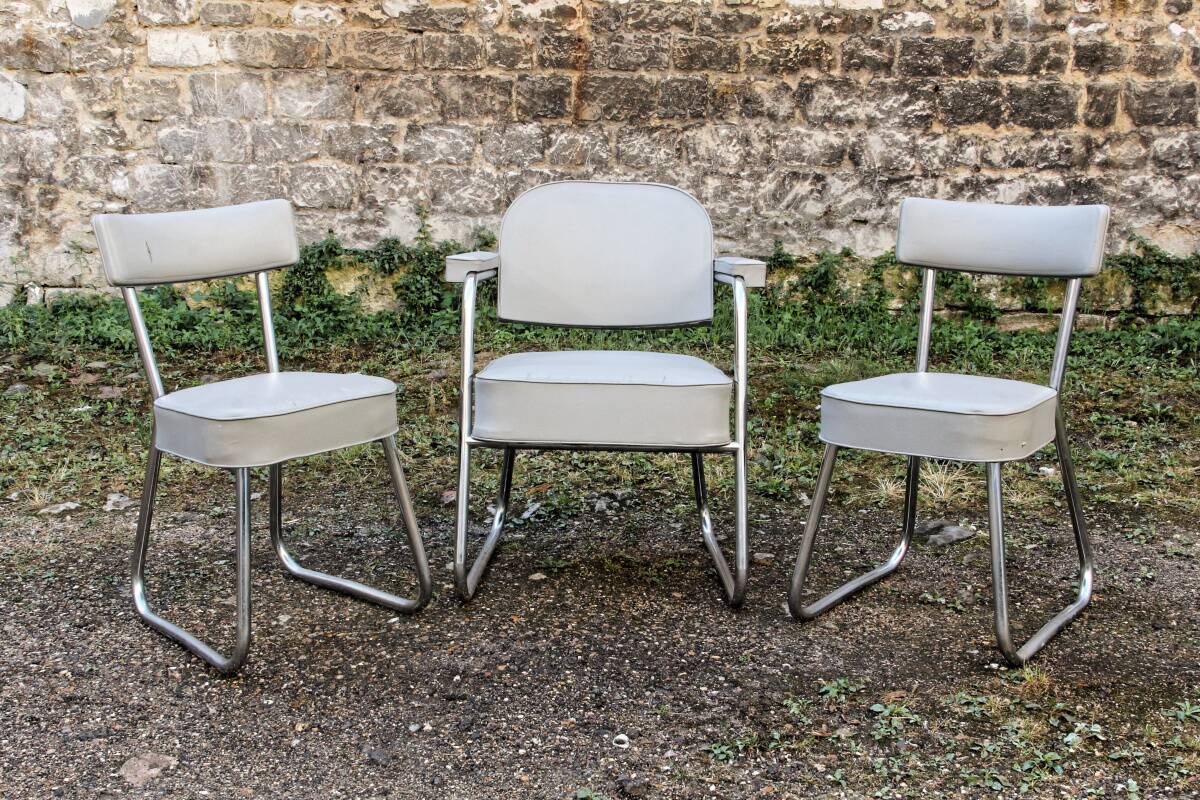 Set of 2 chairs and 1 armchair from the 70s in chrome metal and faux leather.