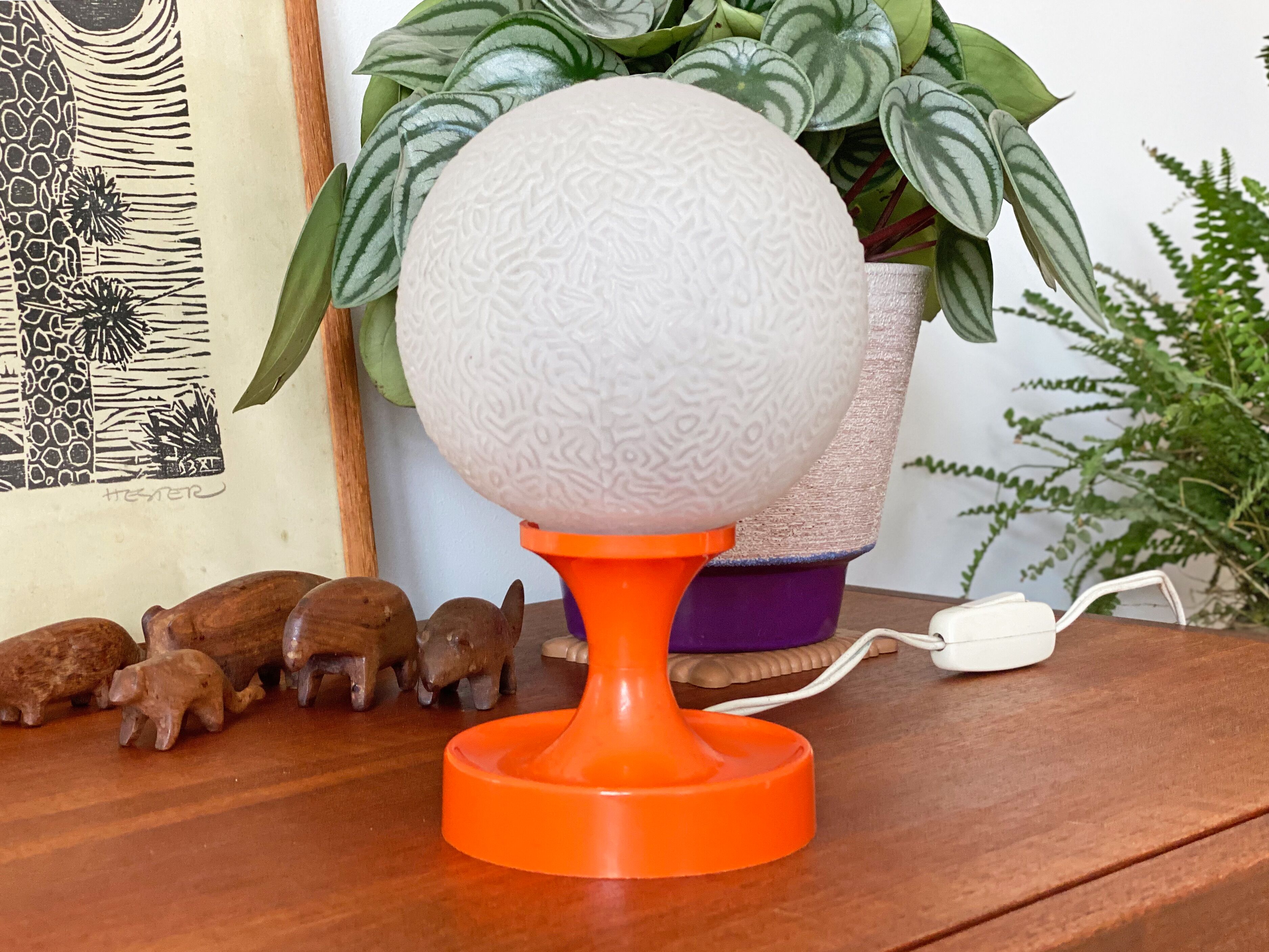 Orange vintage space age eyeball table lamp with a glass globe