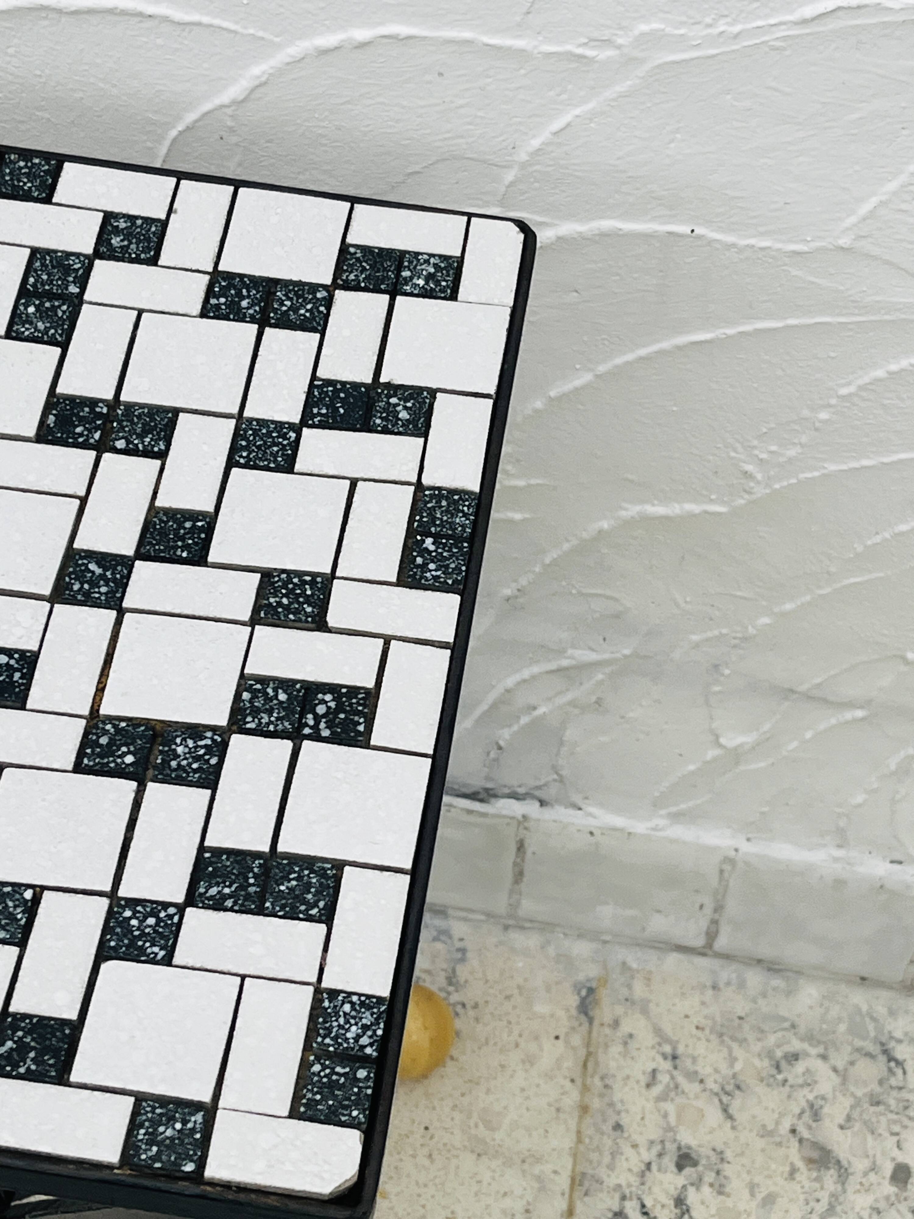 Wrought iron stela and black and white tiled top from the 1960s.