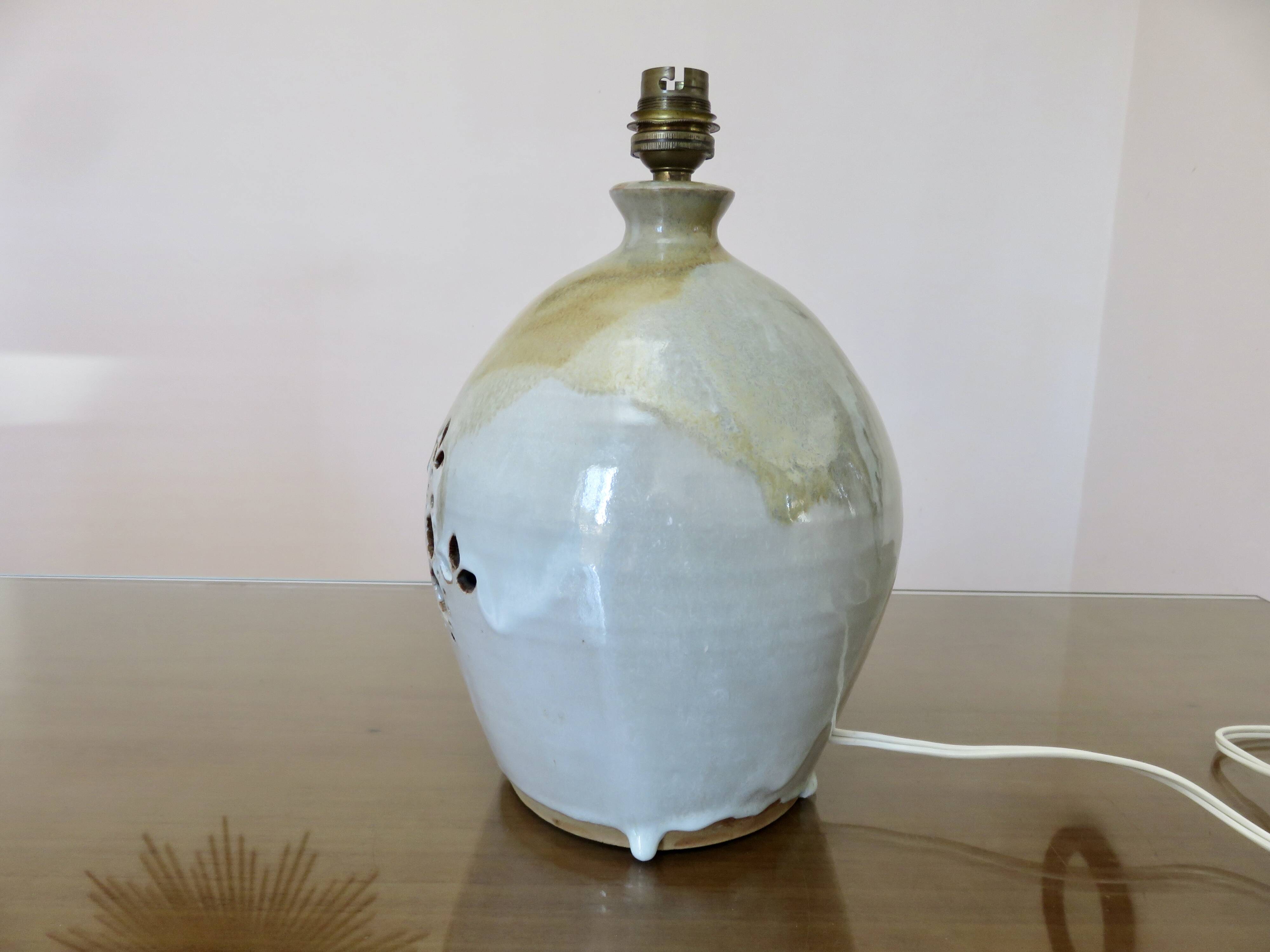 Ceramic lamp with double lighting and openwork design.
