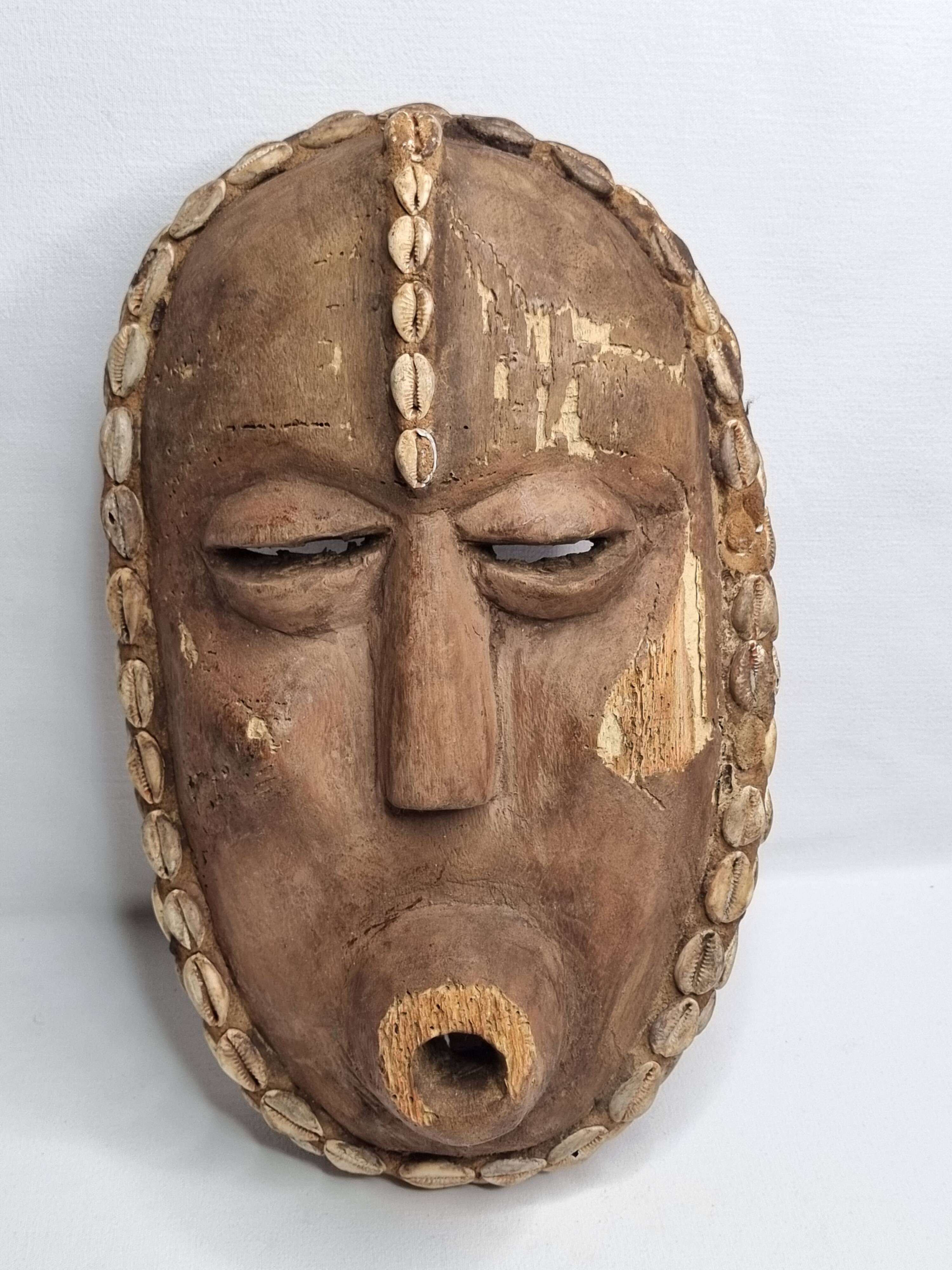 Decorative African mask in carved wood and cowrie shells, Baoulé style, 34 cm