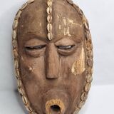 Decorative African mask in carved wood and cowrie shells, Baoulé style, 34 cm