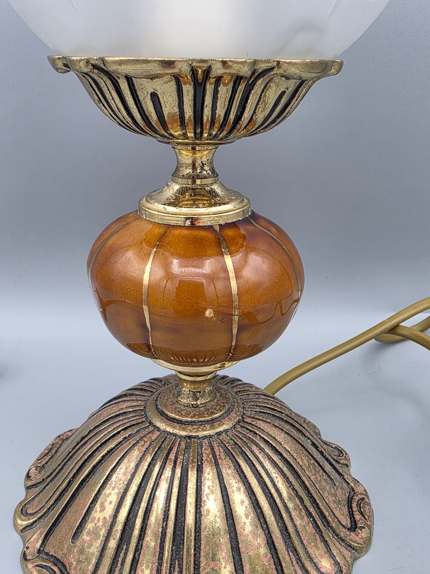 Hollywood Regency bedside lamp in gold metal with a glass globe.