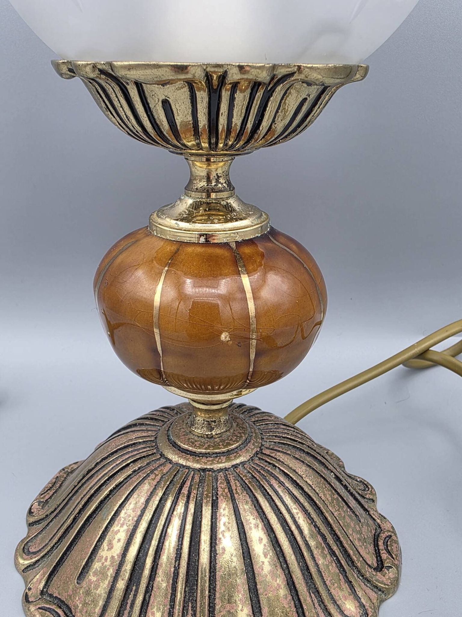 Hollywood Regency bedside lamp in gold metal with a glass globe.