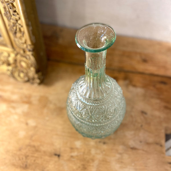 Large blown green glass decanter and relief decoration
