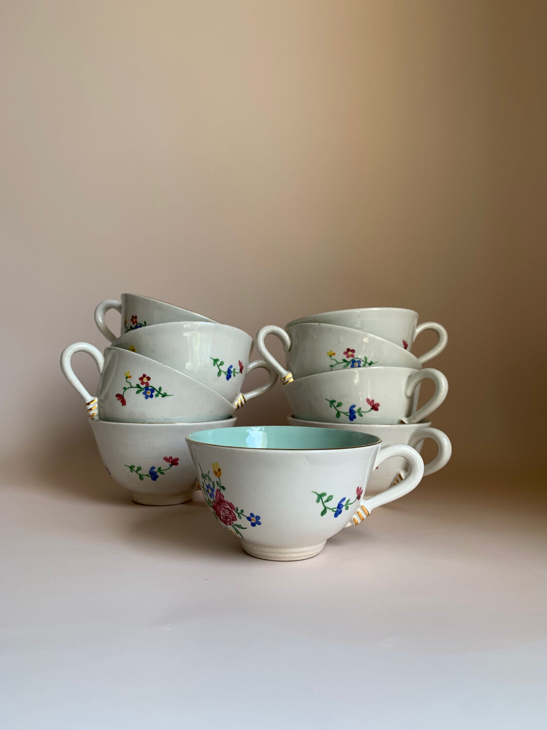 Set of 9 floral Luneville porcelain coffee cups with gold edges