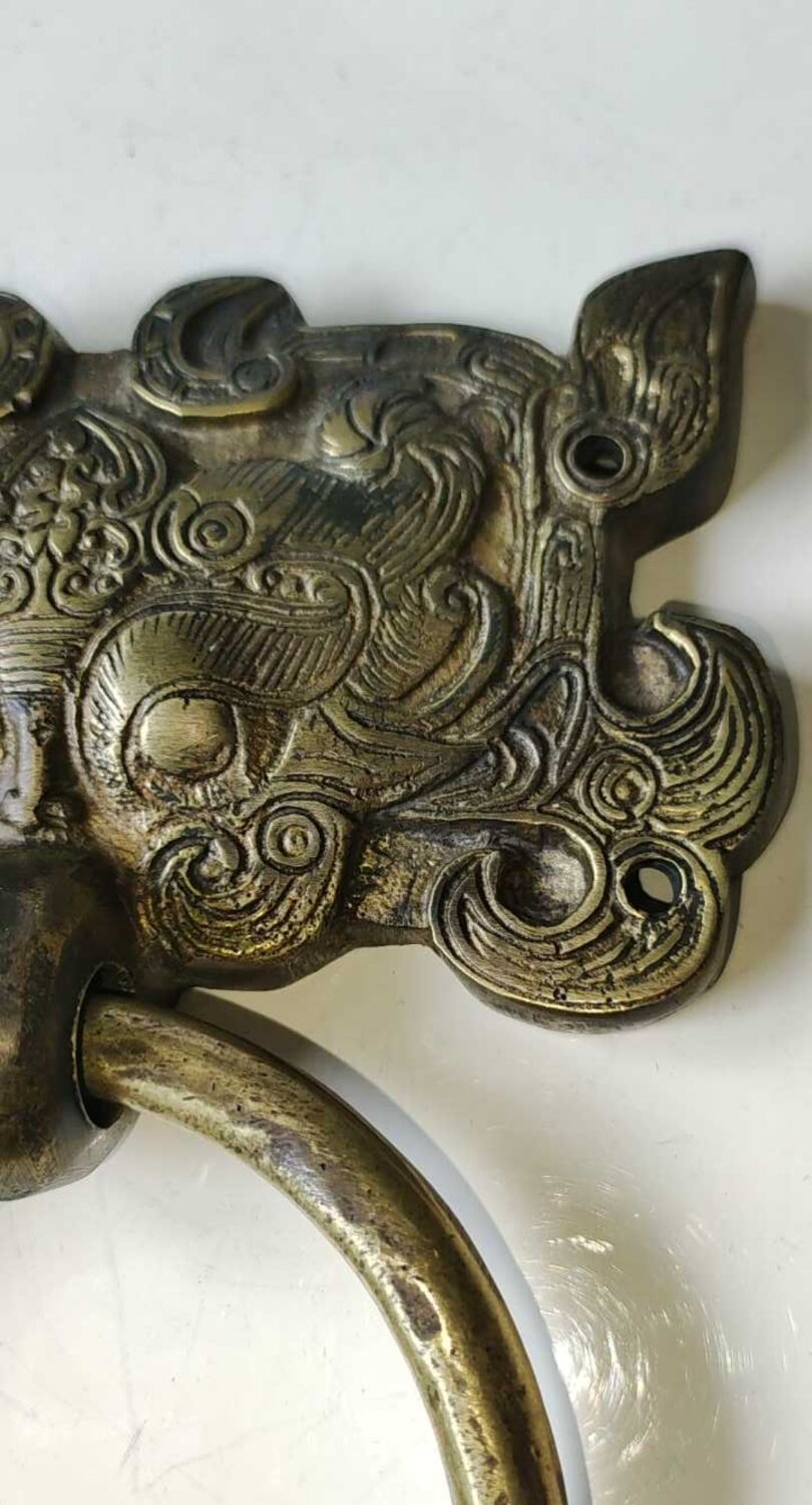 Ancient door knocker, taotié mask, shang dynasty. in bronze golden patina