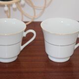 Set of 2 white porcelain cups with gold rim
