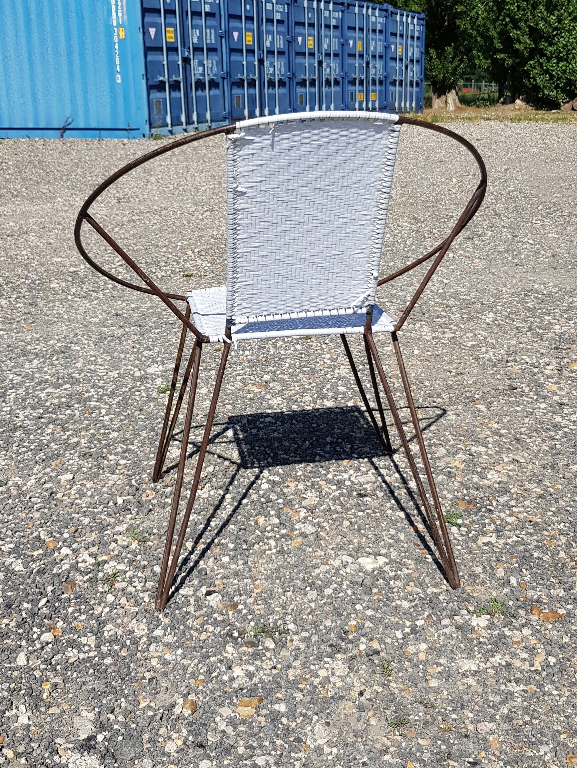 Vintage armchair in black metal and white plastic caning.