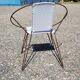 Vintage armchair in black metal and white plastic caning.