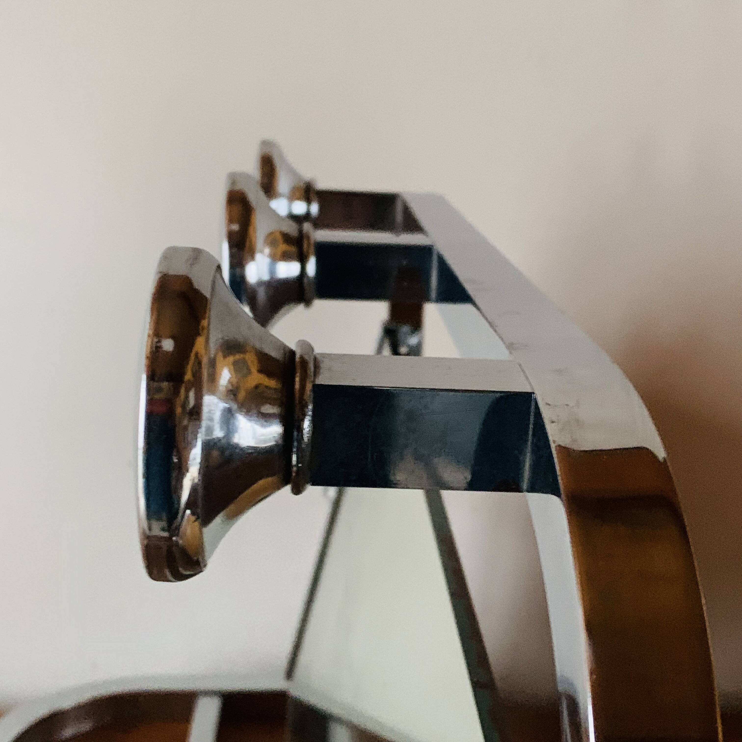 Vintage wall-mounted coat rack in chrome metal with integrated mirror and hat rack
