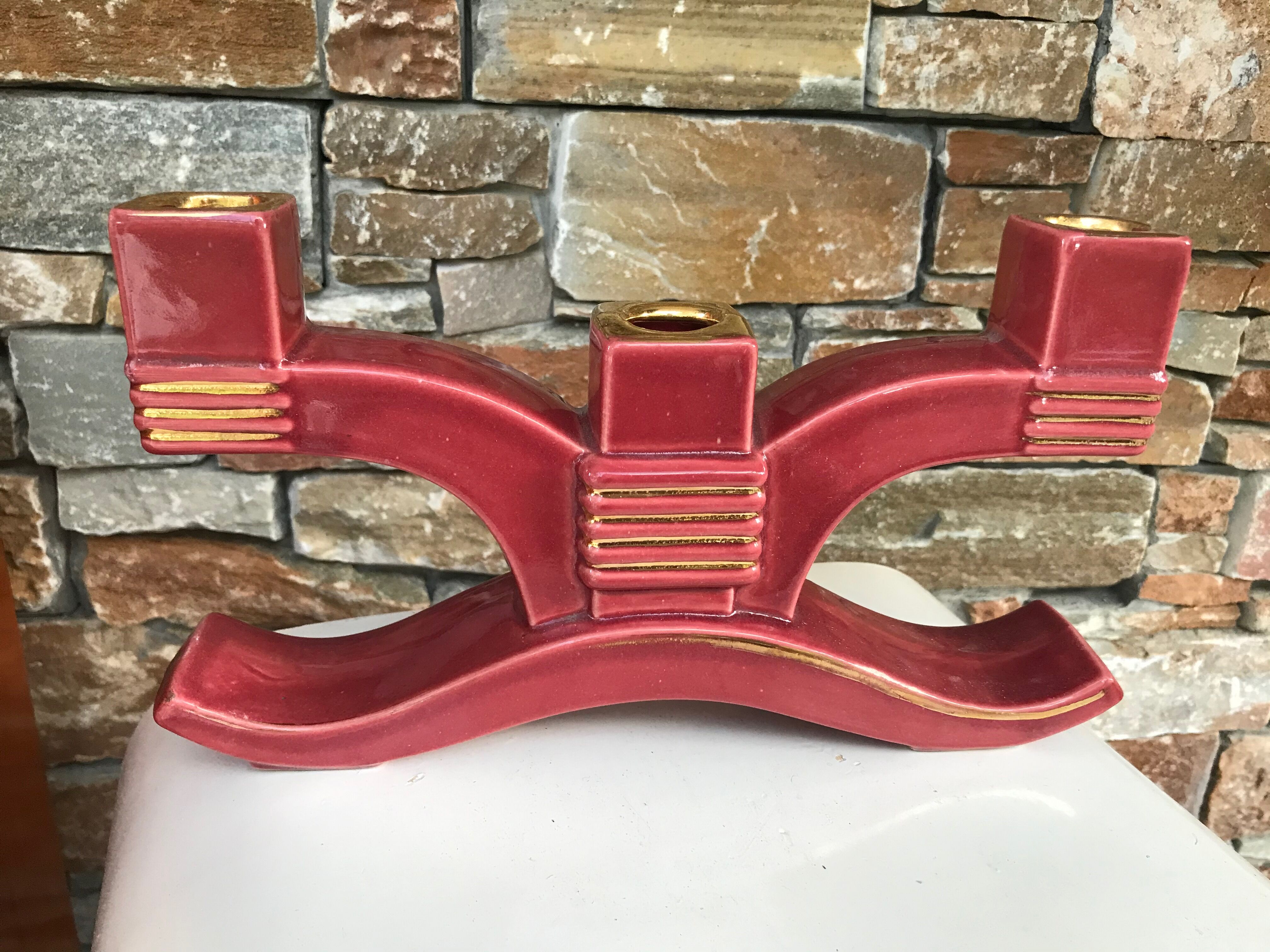 Former pair of burgundy ceramic candlesticks
