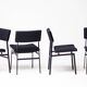 Set of four entirely black Hulmefa dining chairs, Architectural Modernism.