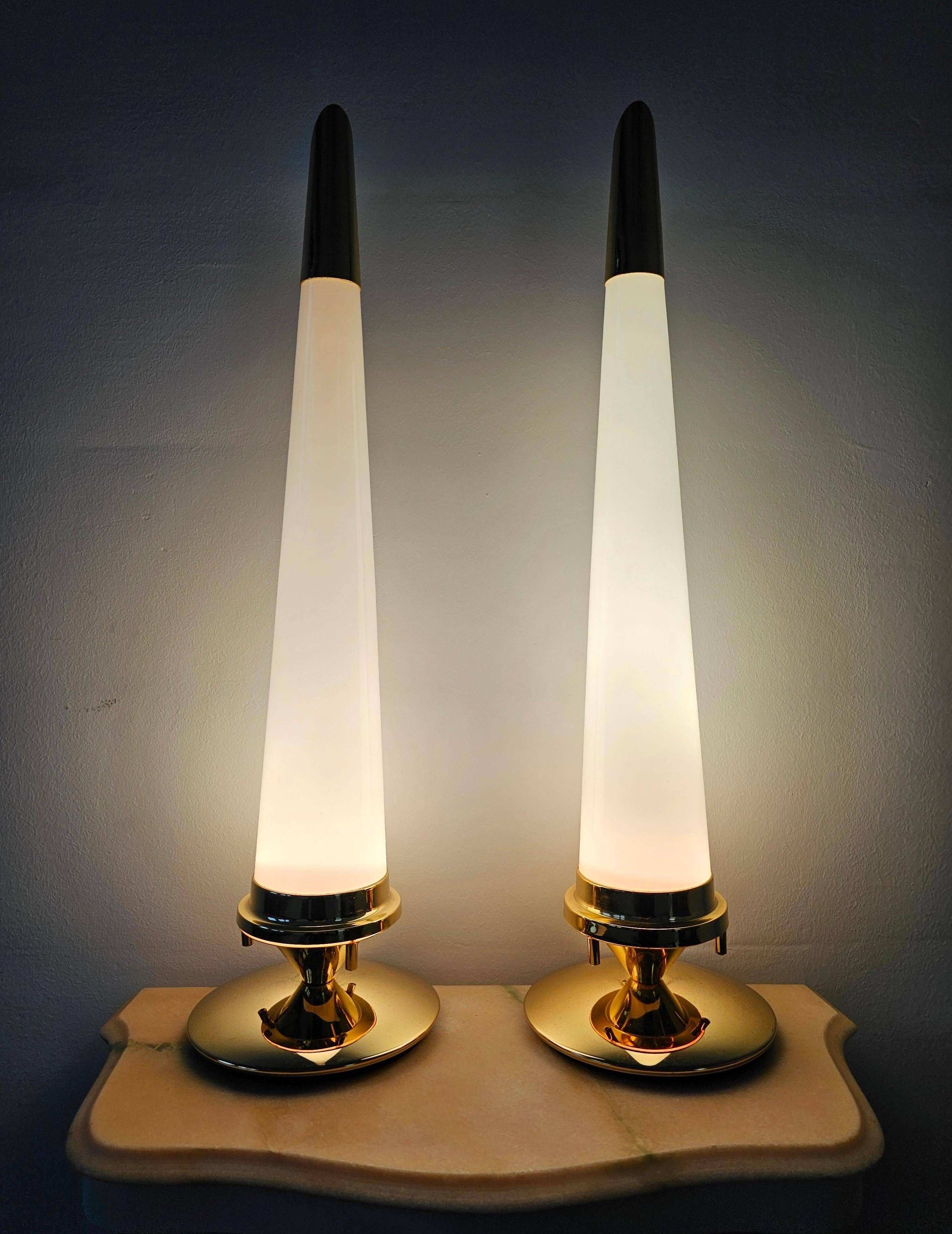 Pair of Hollywood Regency table lamps in brass with glass shades.