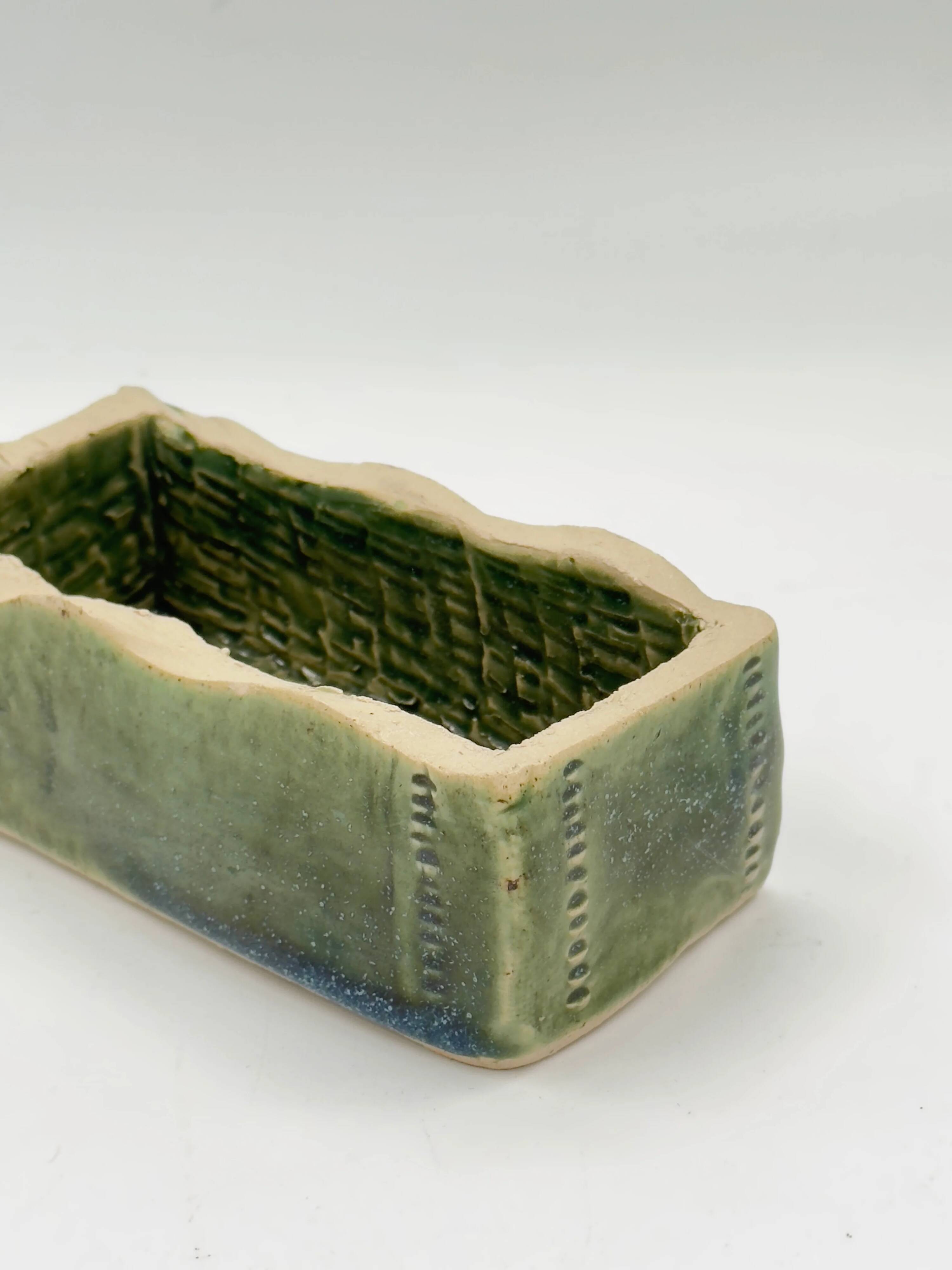 Rectangular ceramic vase signed, woven interior.