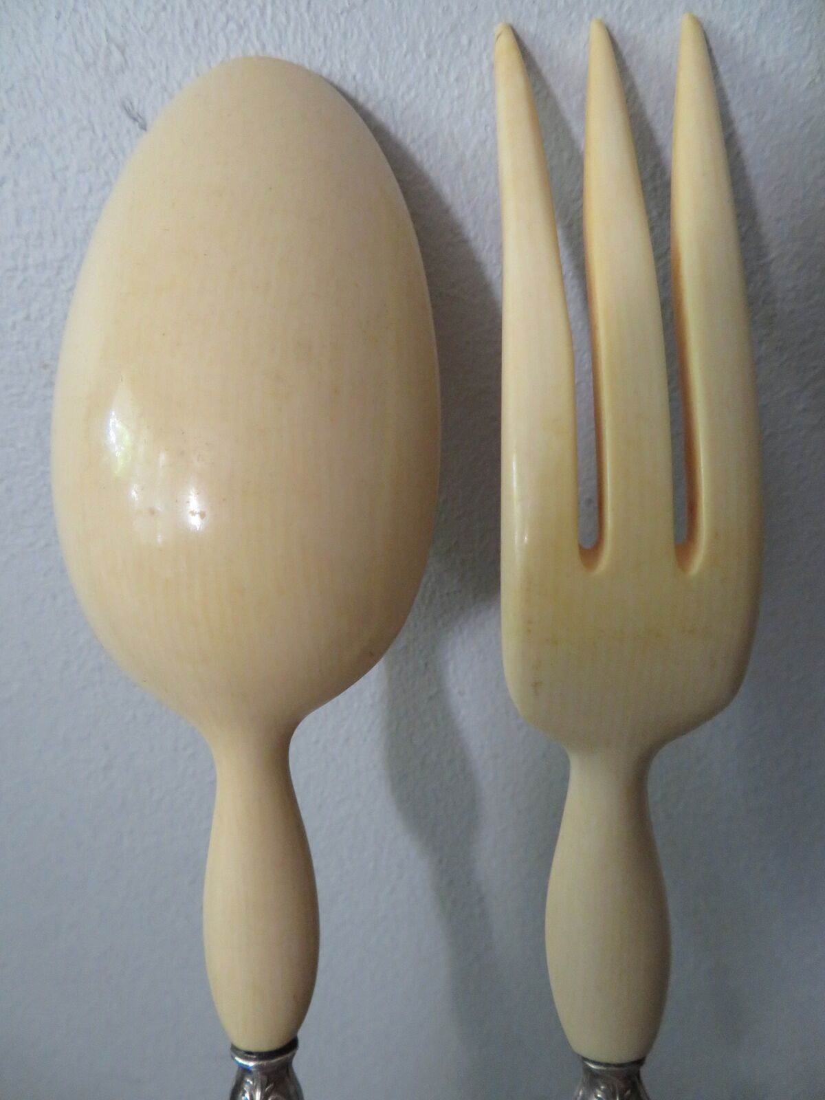 Silver salad servers stuffed in its case