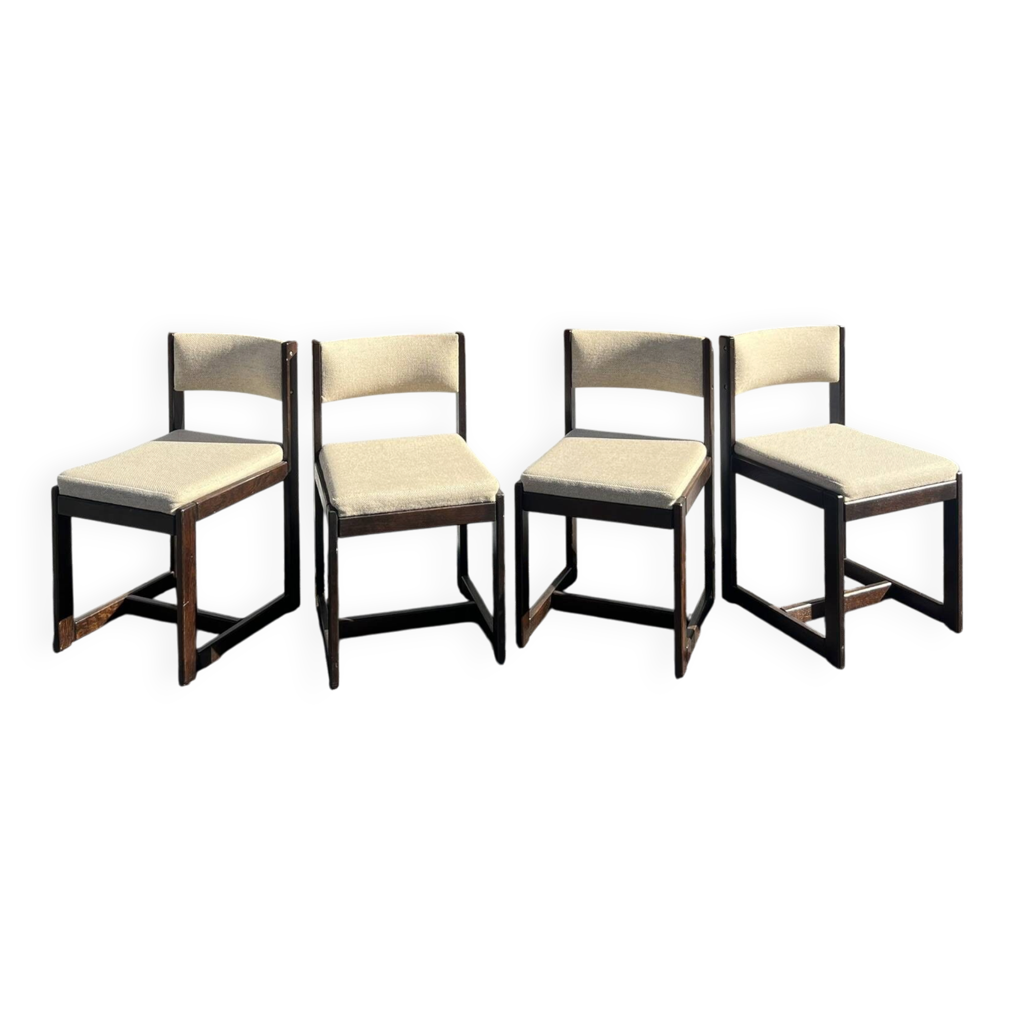 Many mid-century vintage wooden and fabric chairs.