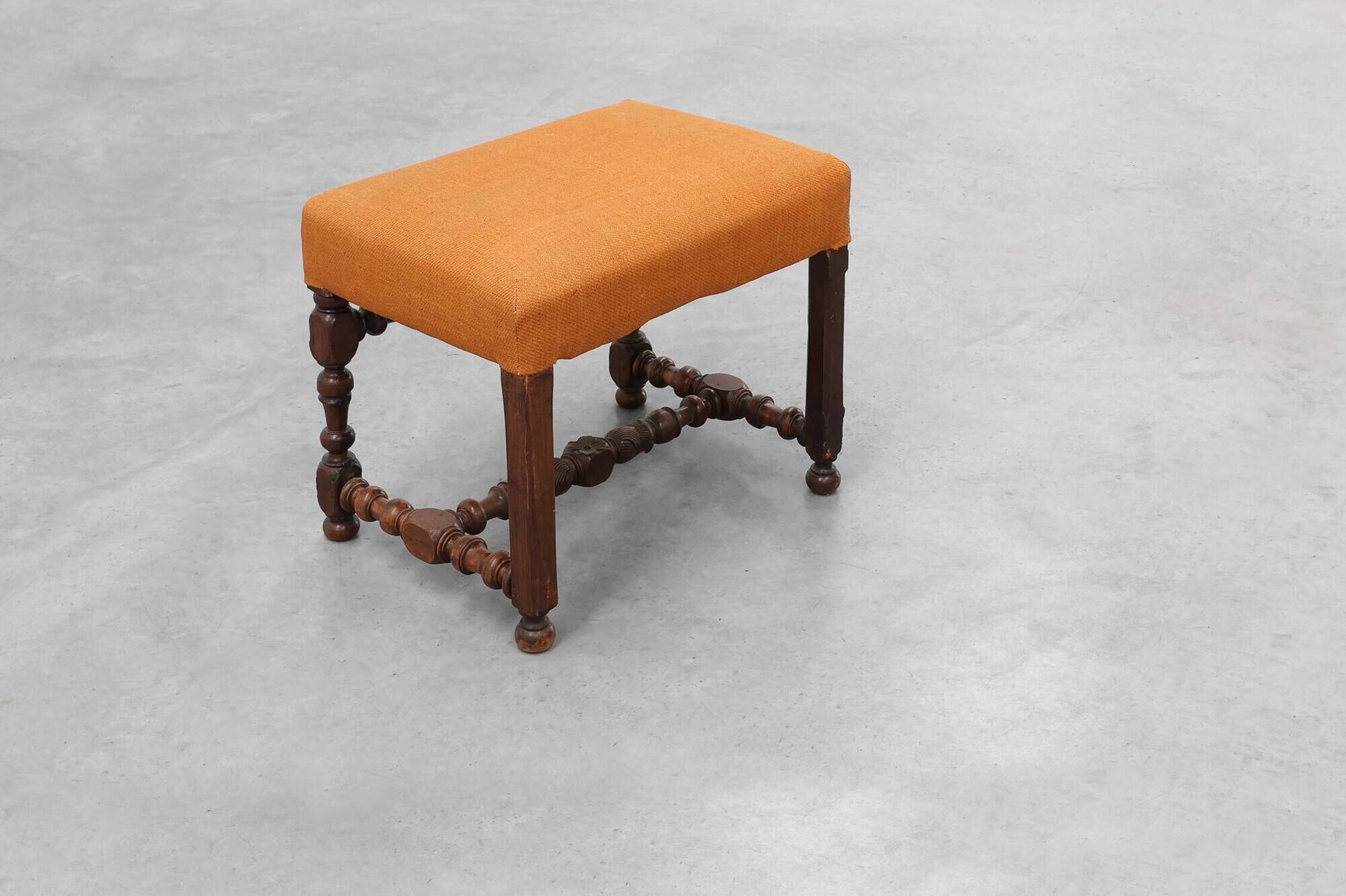 Louis XIII walnut stool with carved turned stretchers and upholstered seat