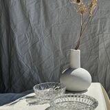 Circular glass ashtray with stylized petal patterns