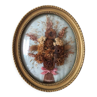 Golden vintage frame with bouquet of dried flowers under globe, wedding bouquet, antique bouquet