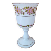 Footed glass in the shape of a chalice in white opaline with a floral decoration.