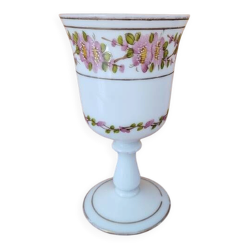 Footed glass in the shape of a chalice in white opaline with a floral decoration.