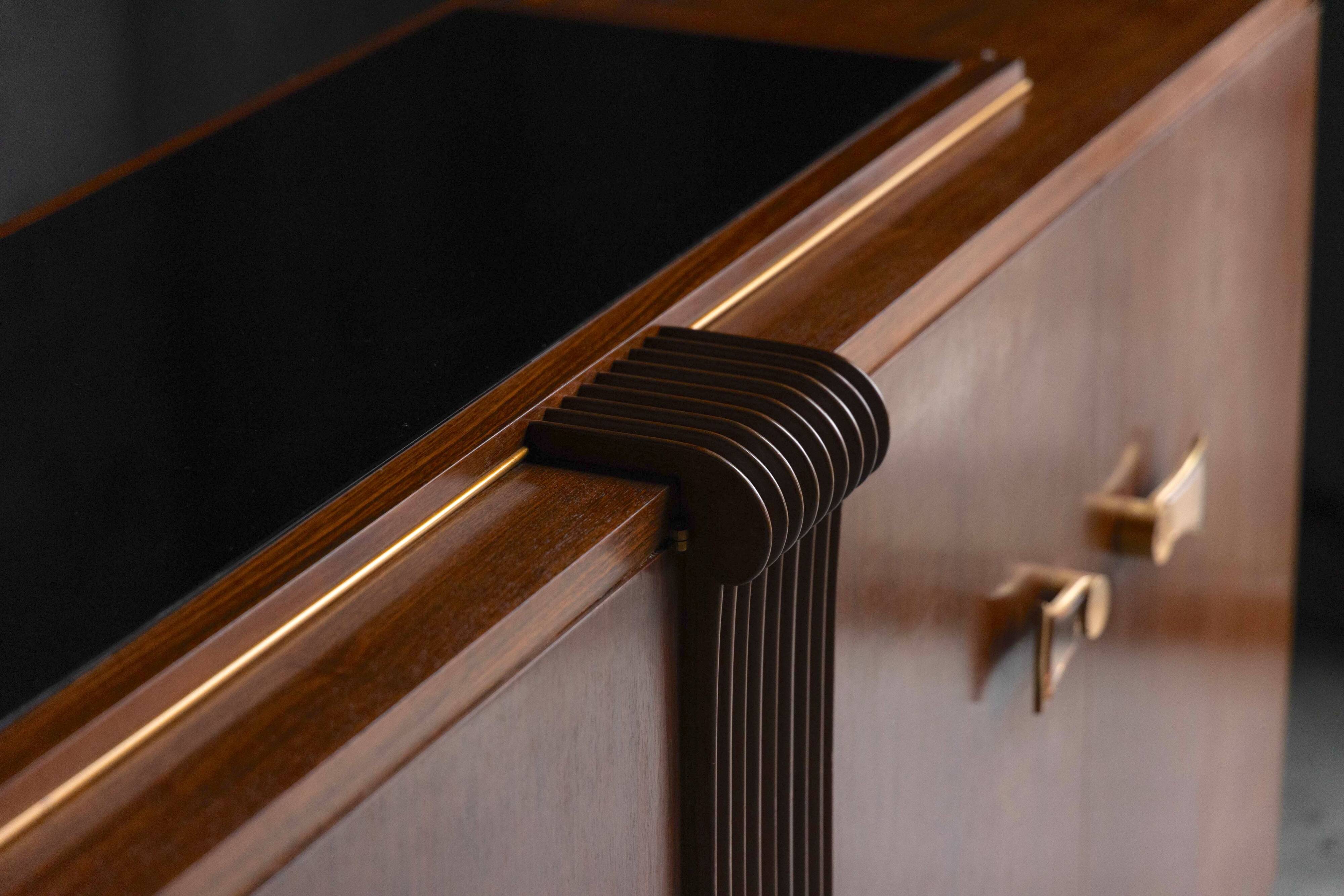 Art Deco walnut sideboard with brass details and sculptural base, France, 1930s