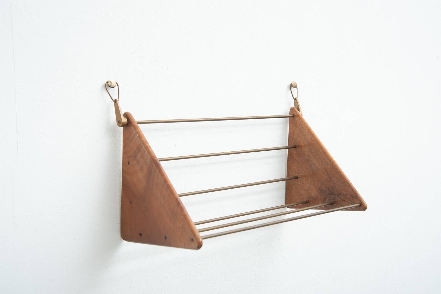 Wall-mounted walnut bookshelf by Carl Auböck, 1950s