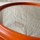 Vintage round wall mirror in orange painted wood - diameter: 48 cm
