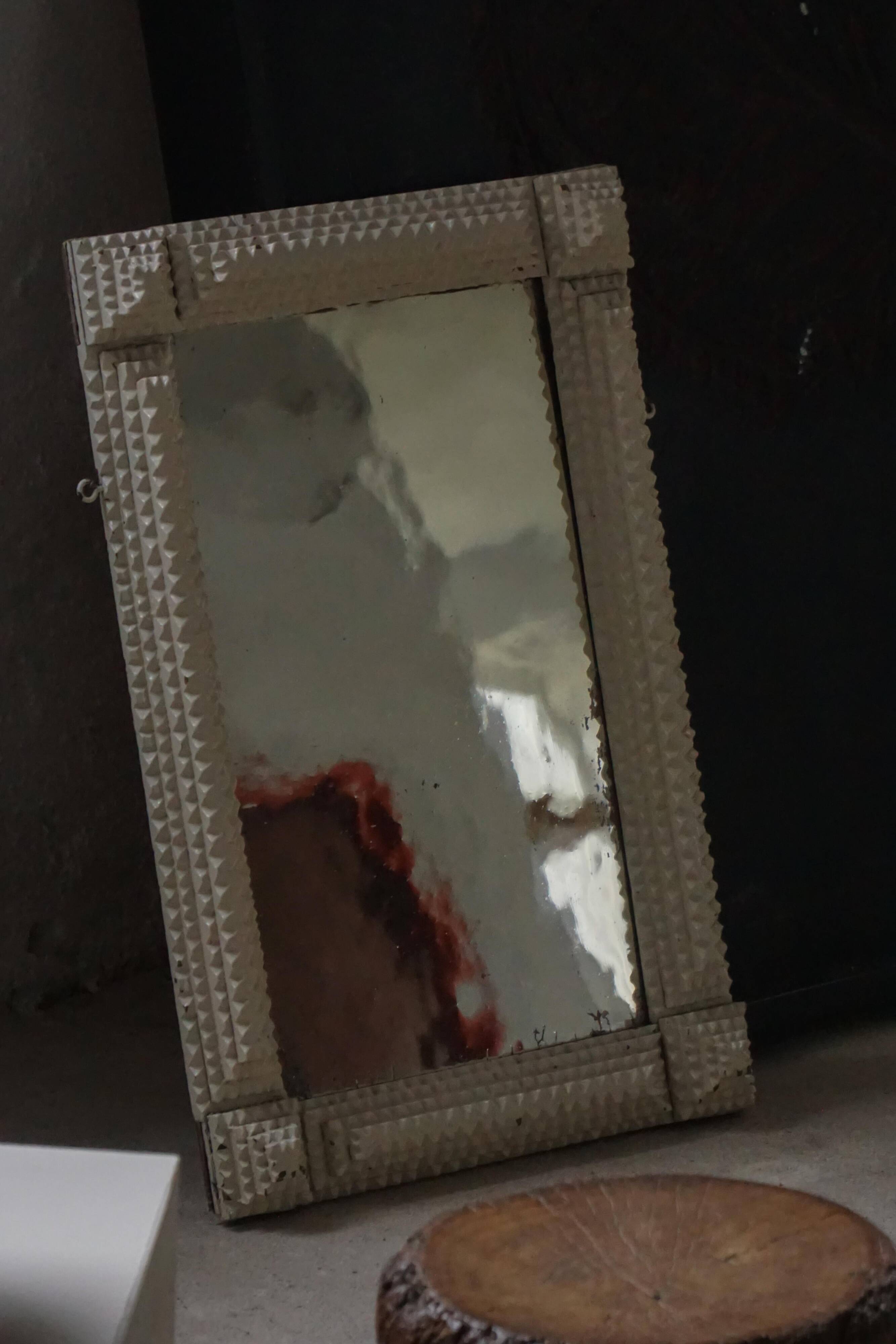 Wall mirror in tramp art style, hand-carved with a painted white frame, early 1900s.