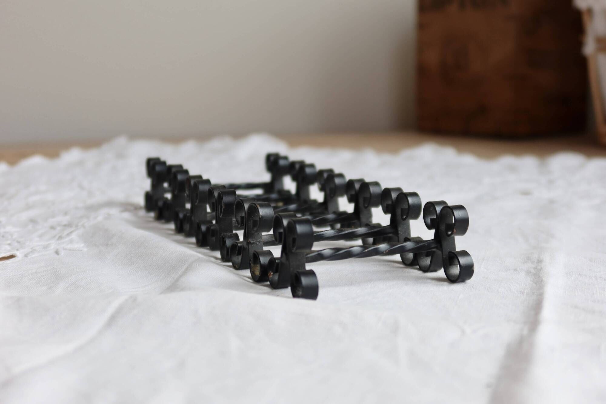6 vintage black metal knife rests with scroll decorations