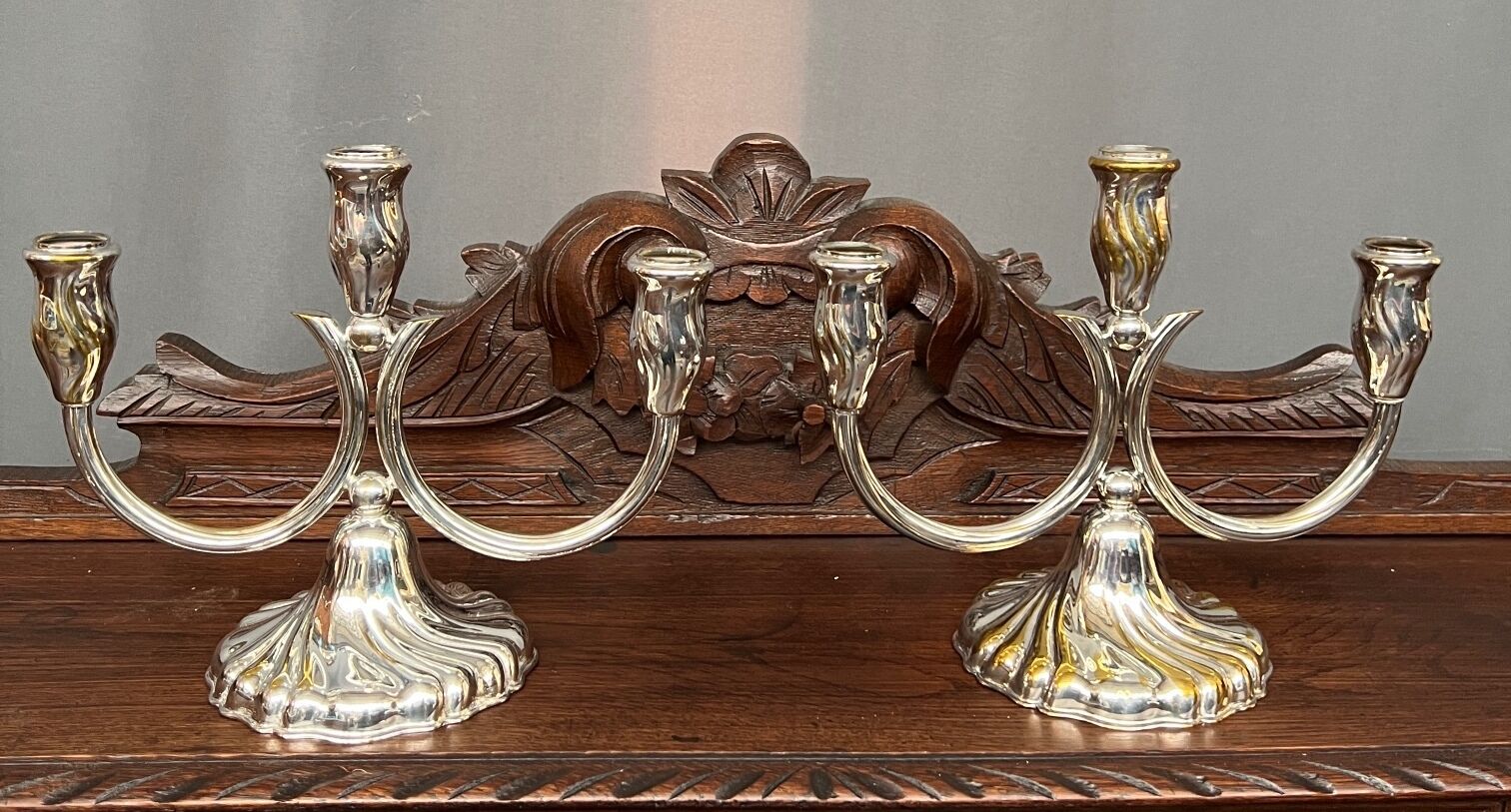 A pair of candlesticks. silver metal with gold decoration.