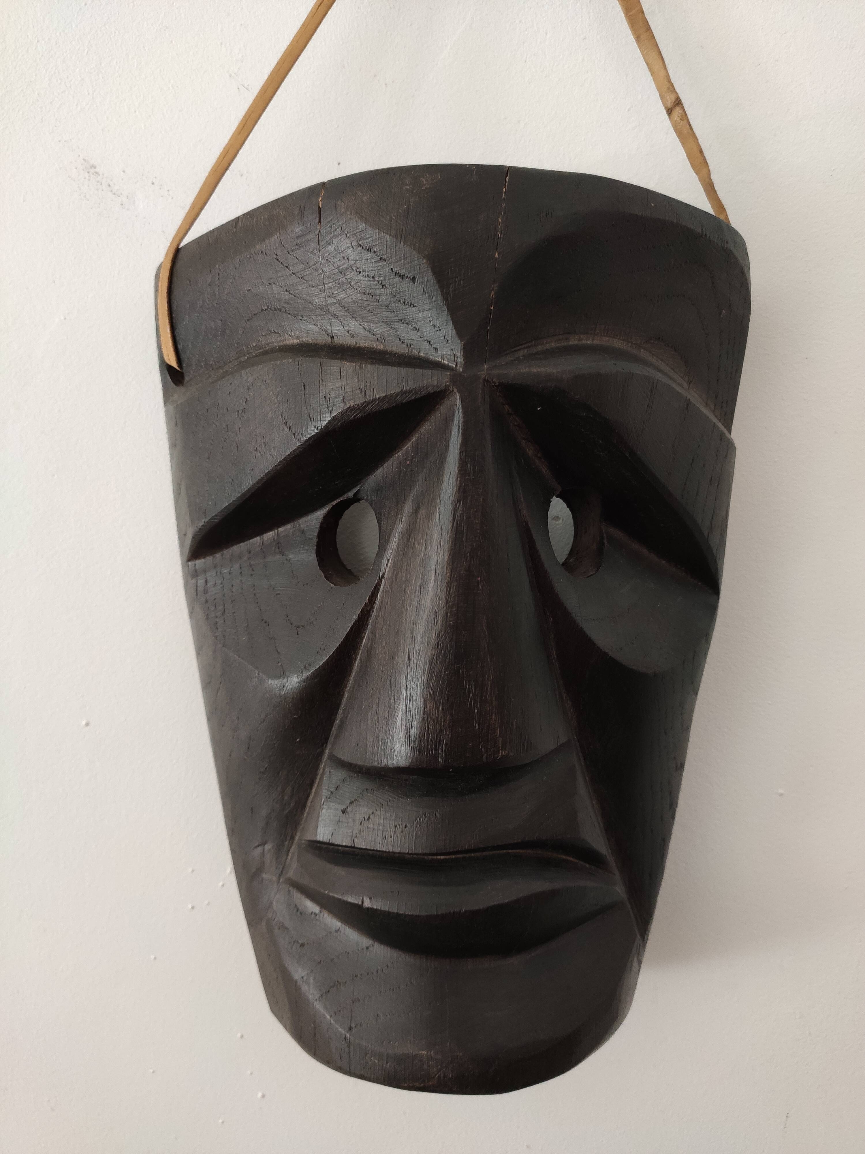 Ethnic ebony wood mask for display or hanging.