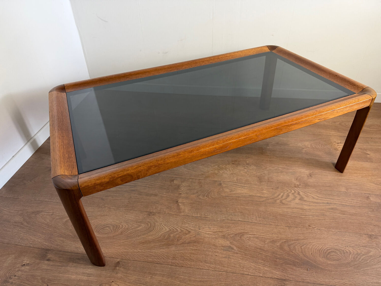 Large Scandinavian coffee table in teak and smoked glass.
