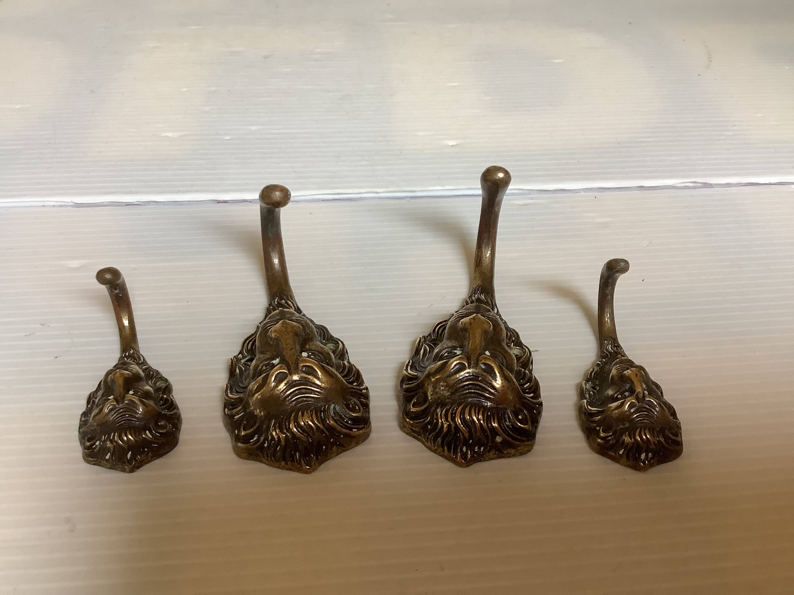 4 lion coat hooks in brass