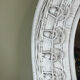 Half-moon wicker mirror
