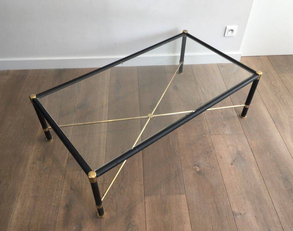 Brass coffee table upholstered in black leather. In the style of Jacques Adnet.