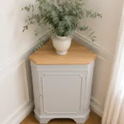 Vintage English corner cabinet enhanced in pearl grey, wooden top.
