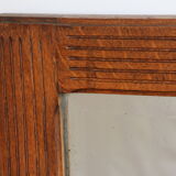 Beveled mirror grooved wood