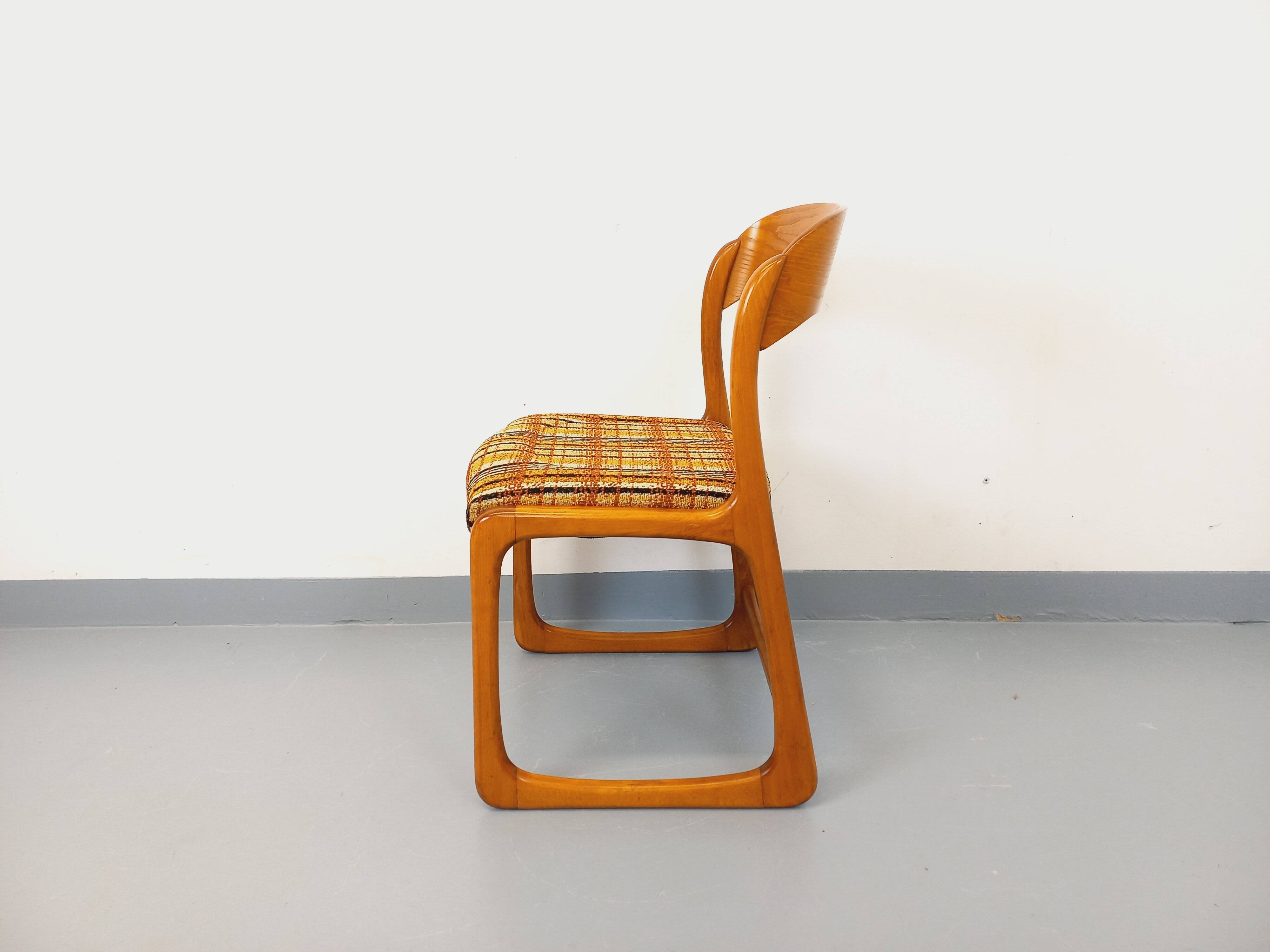 Vintage sled chair by Baumann in wood and wool fabric.