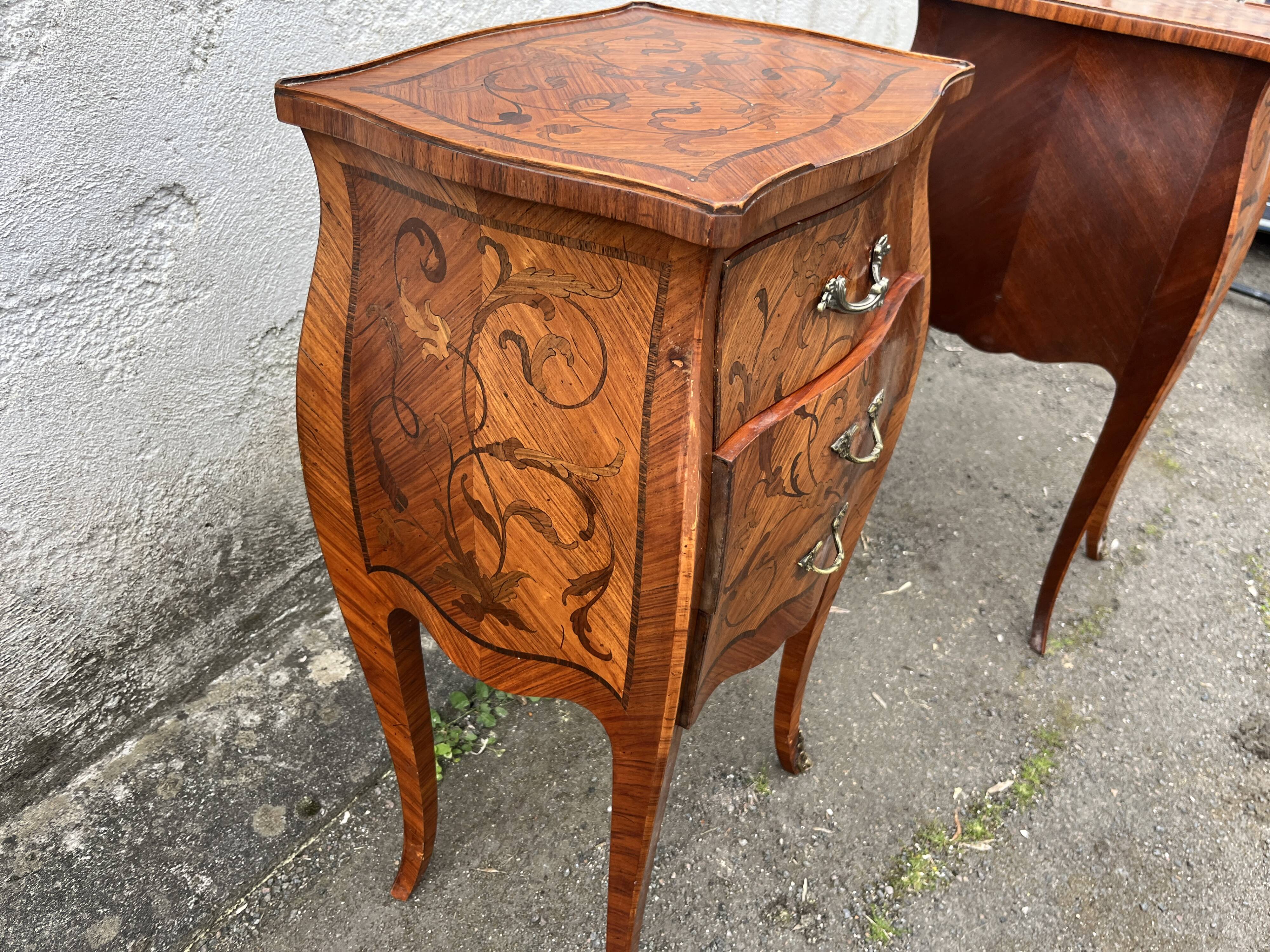 Pair of bedside tables with bombé shape, marquetry, and bronze in Louis XV style.