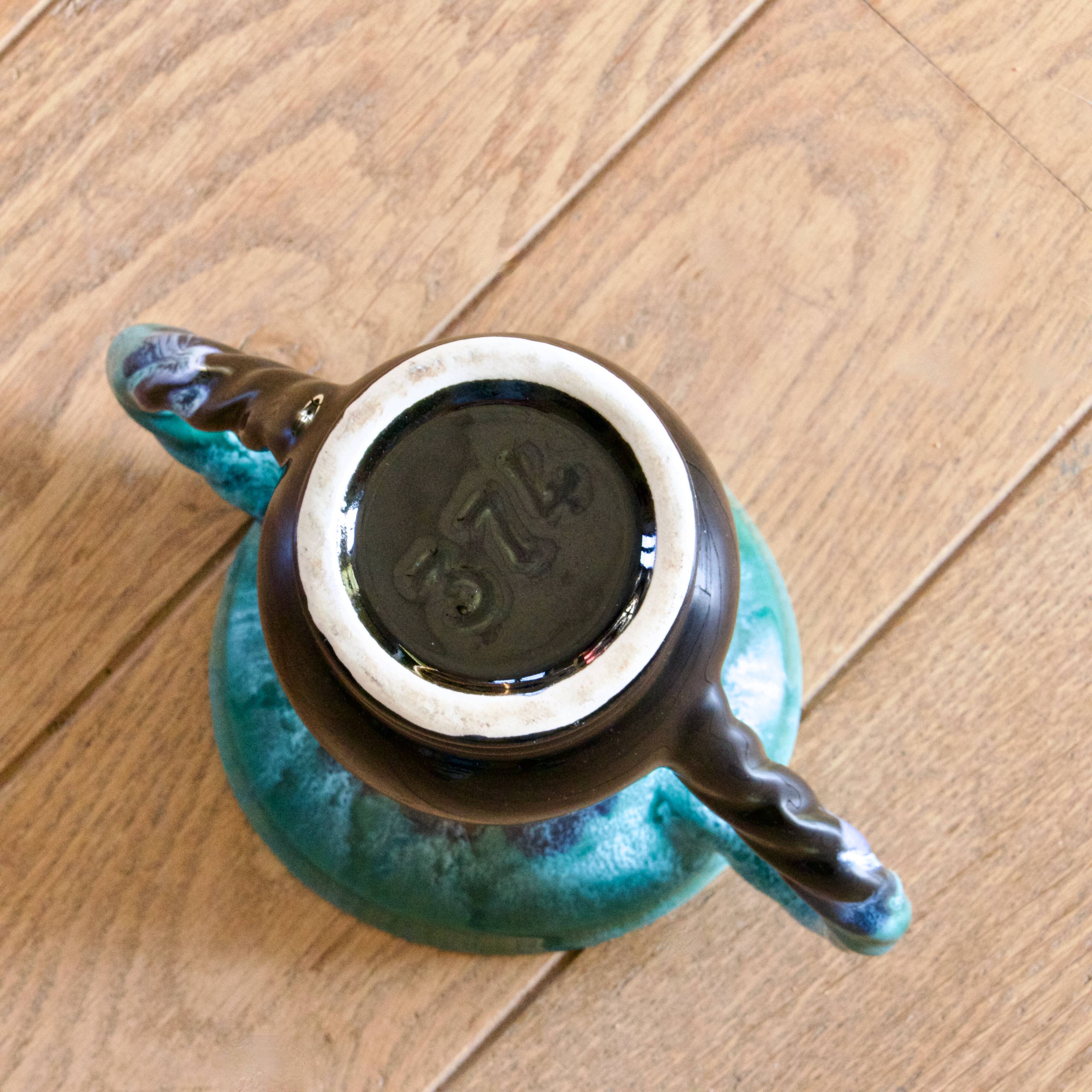 Ancient amphora vase in turquoise glazed stoneware.