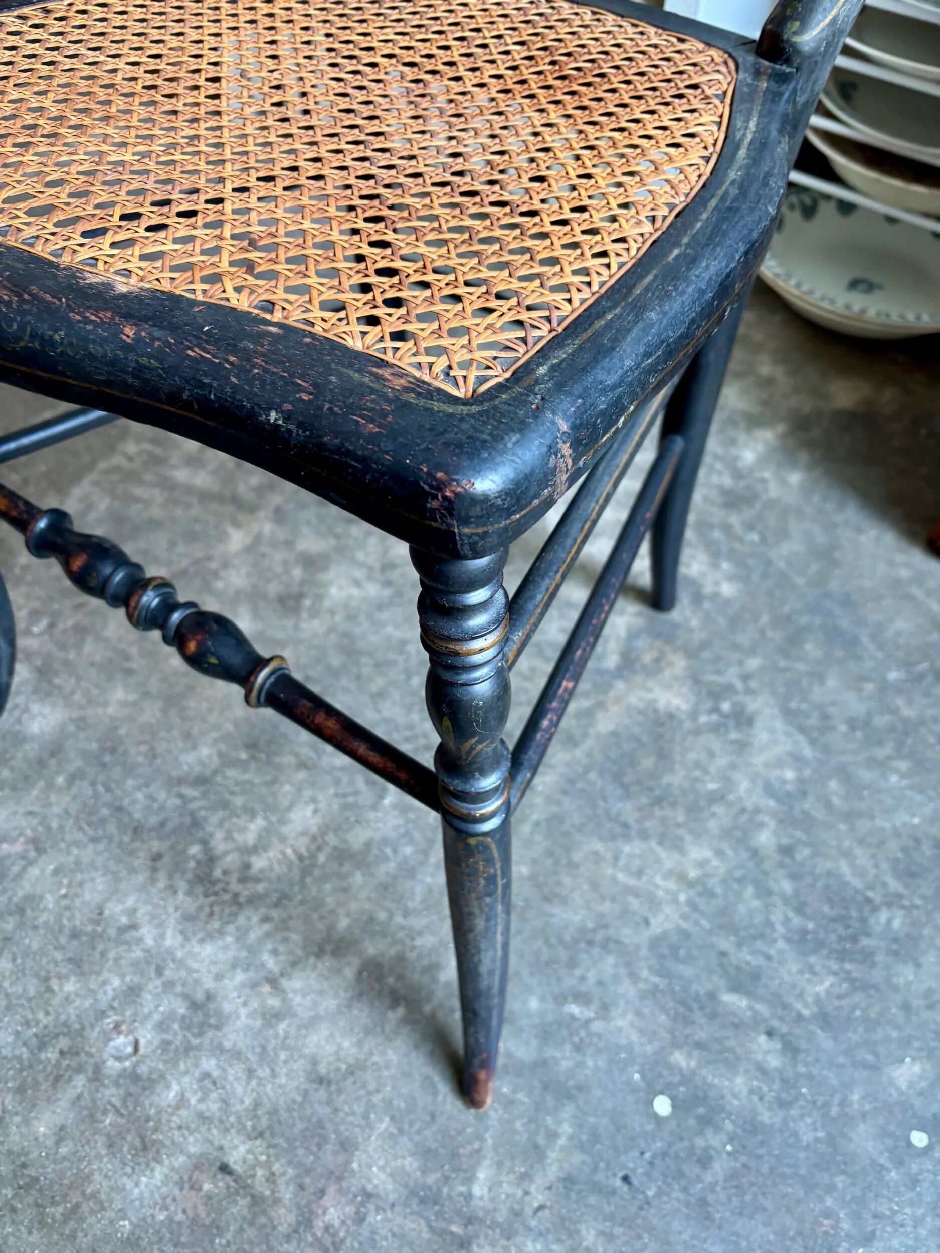 Napoleon III chair in black and gold wood with caning.