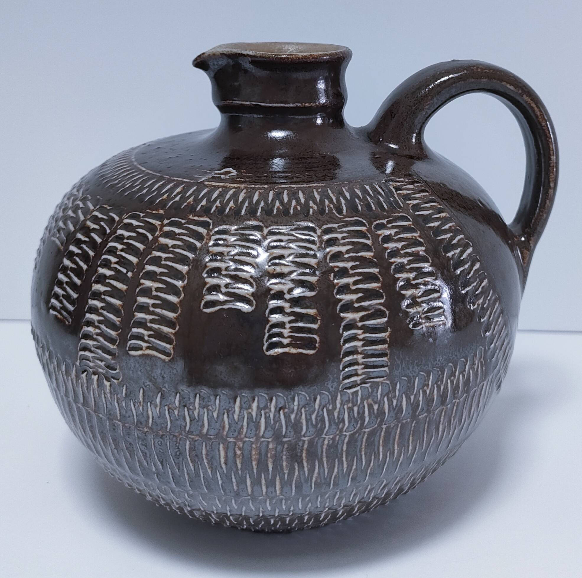 Vintage scarified glazed stoneware pitcher