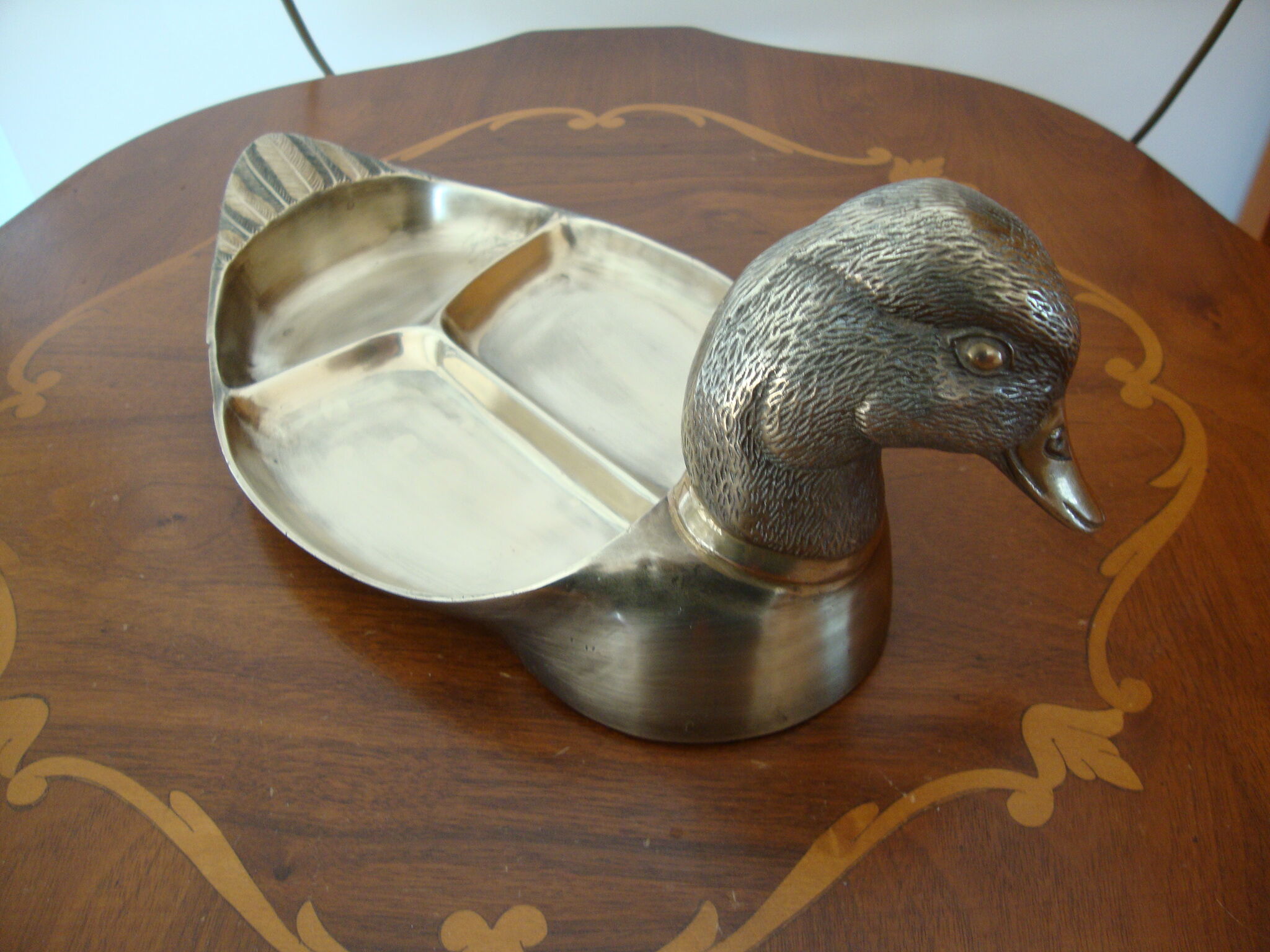 Empty pocketed old duck in solid brass