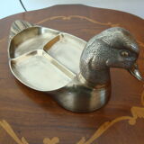 Empty pocketed old duck in solid brass
