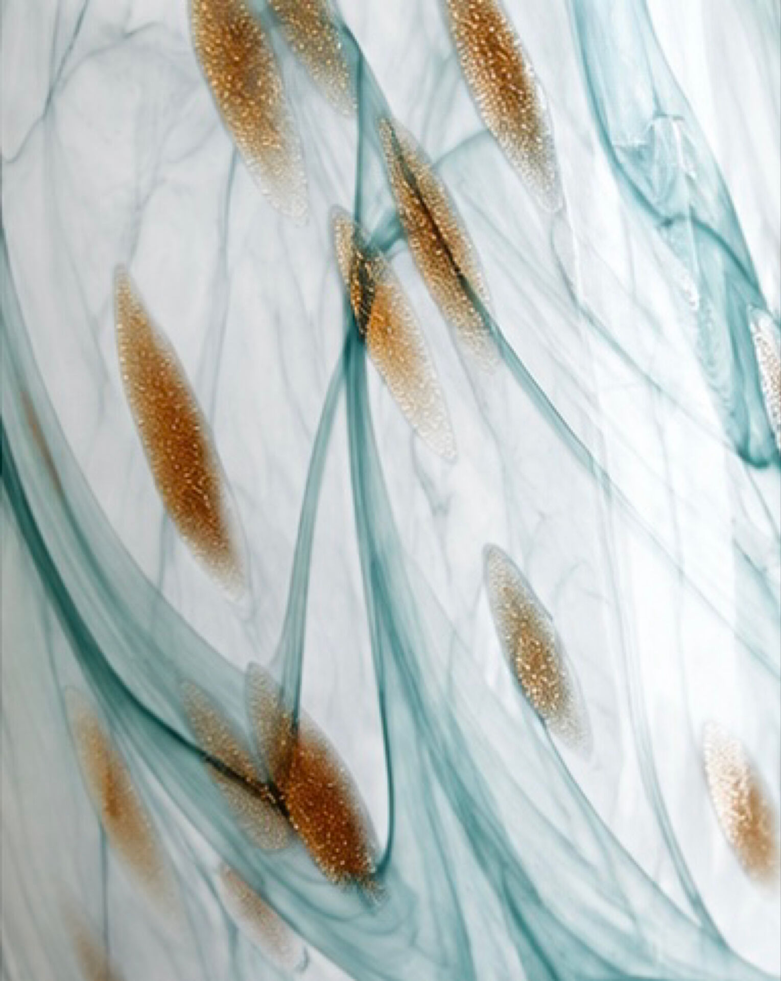 Blown glass vase marbled in white, water green, and with golden inclusions –