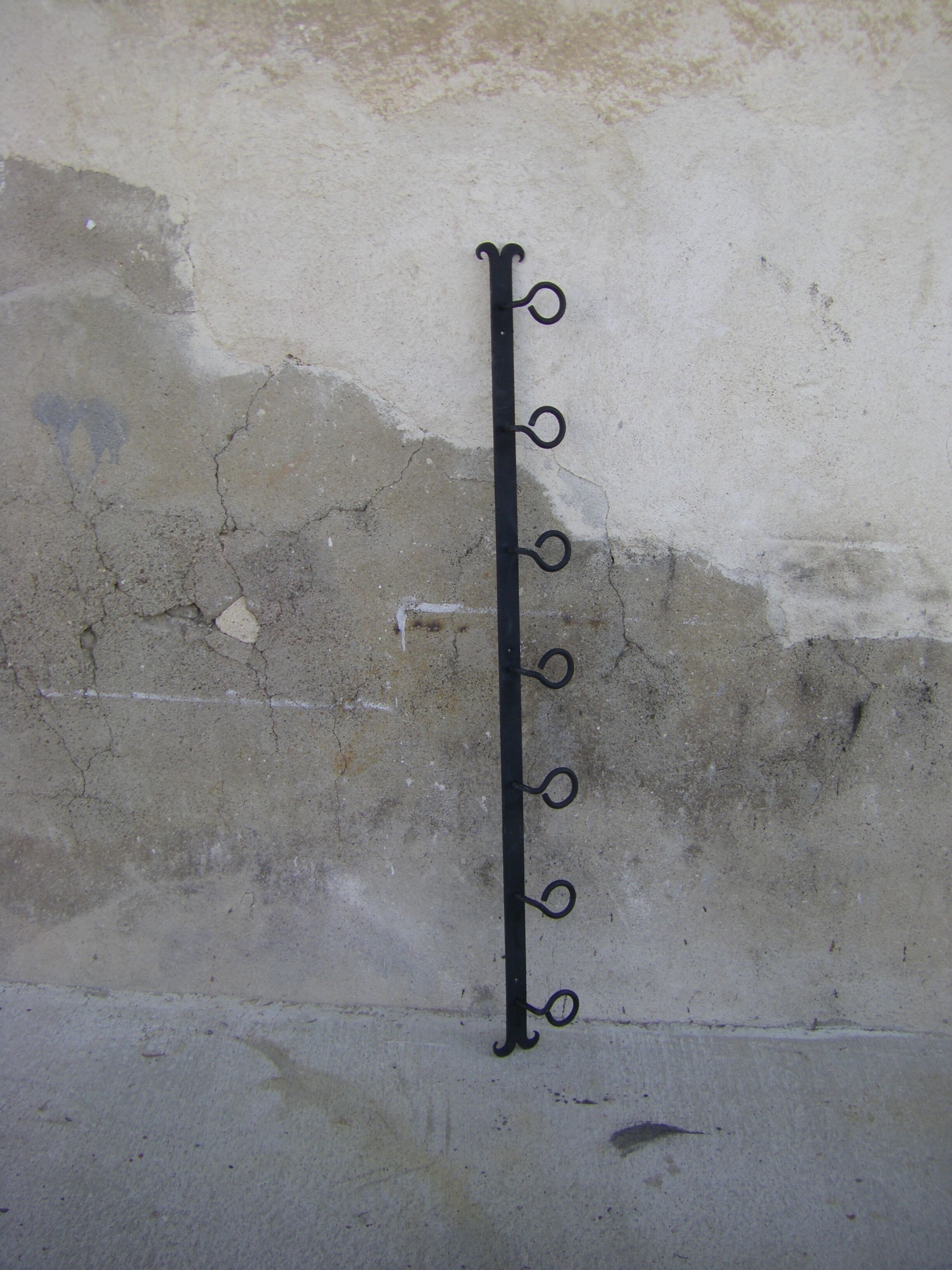 Wall-mounted wrought iron coat racks.