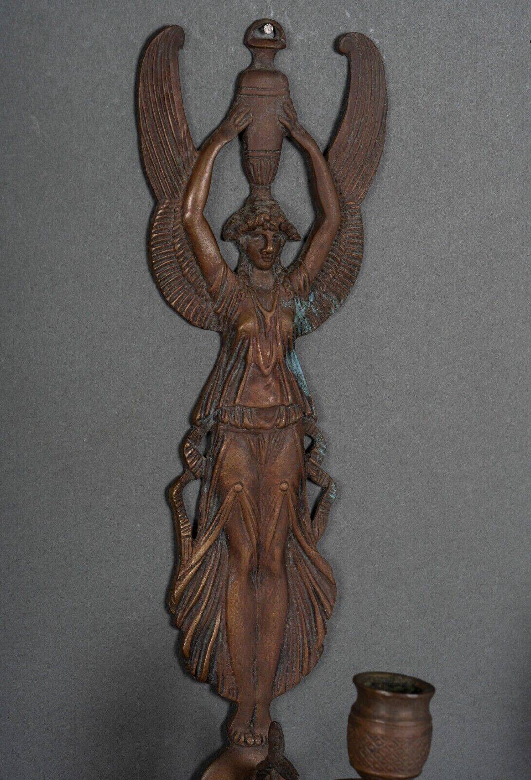 Pair of Empire period bronze sconces decorated with a winged woman