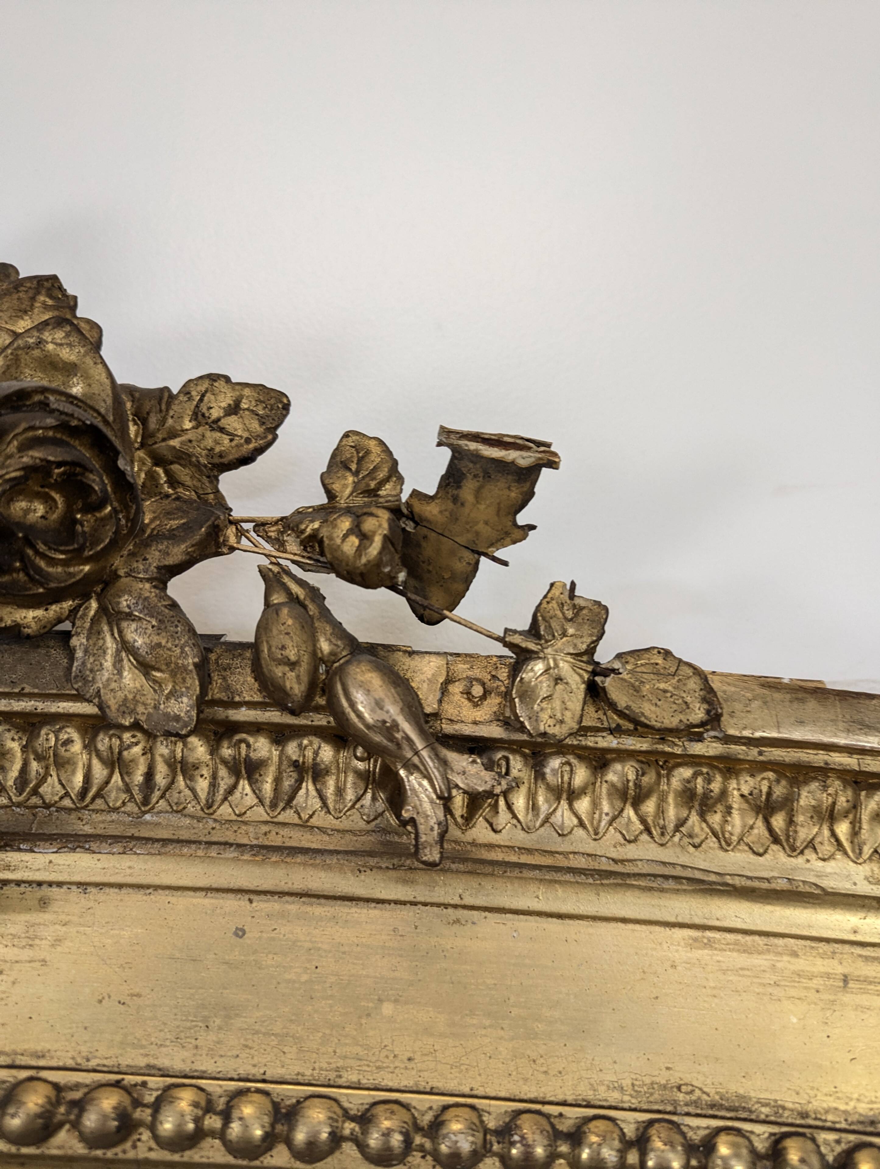 Large gilded wooden mirror in Louis XVI style from the late 19th century.